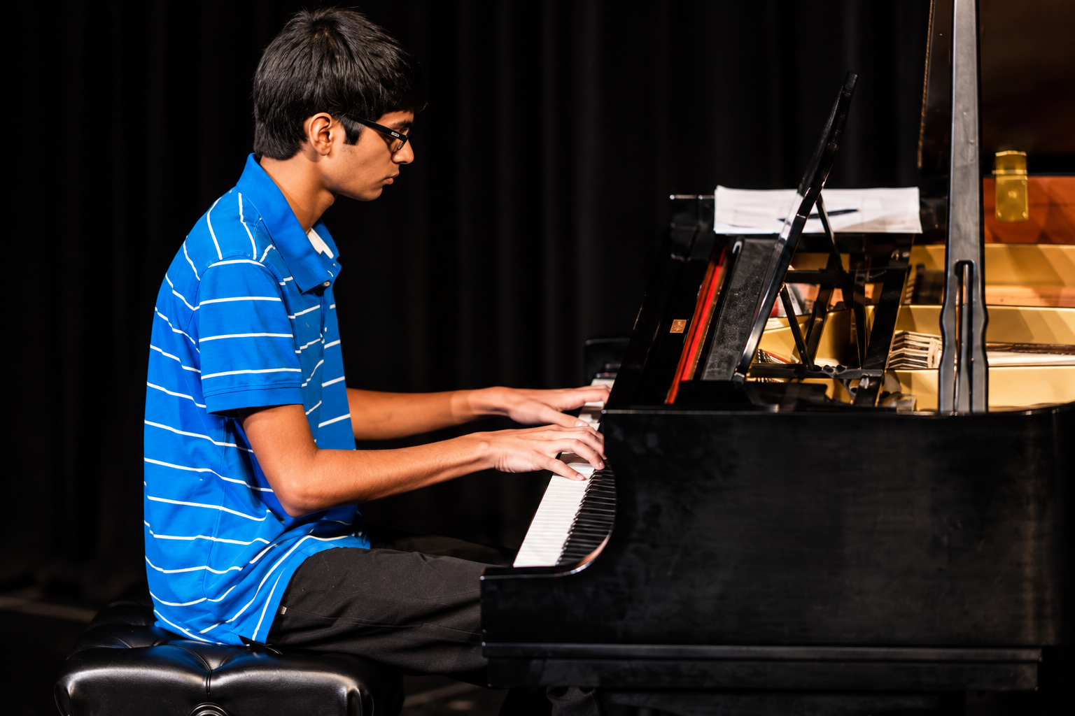 Pianist performing at a grand piano · MBMS archive