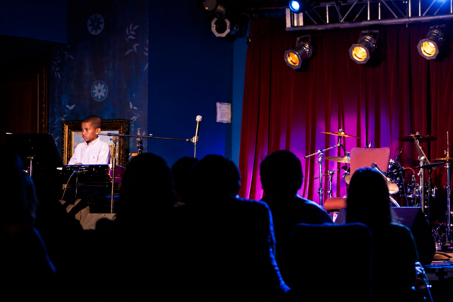Musicians performing under blue stage lights · MBMS archive