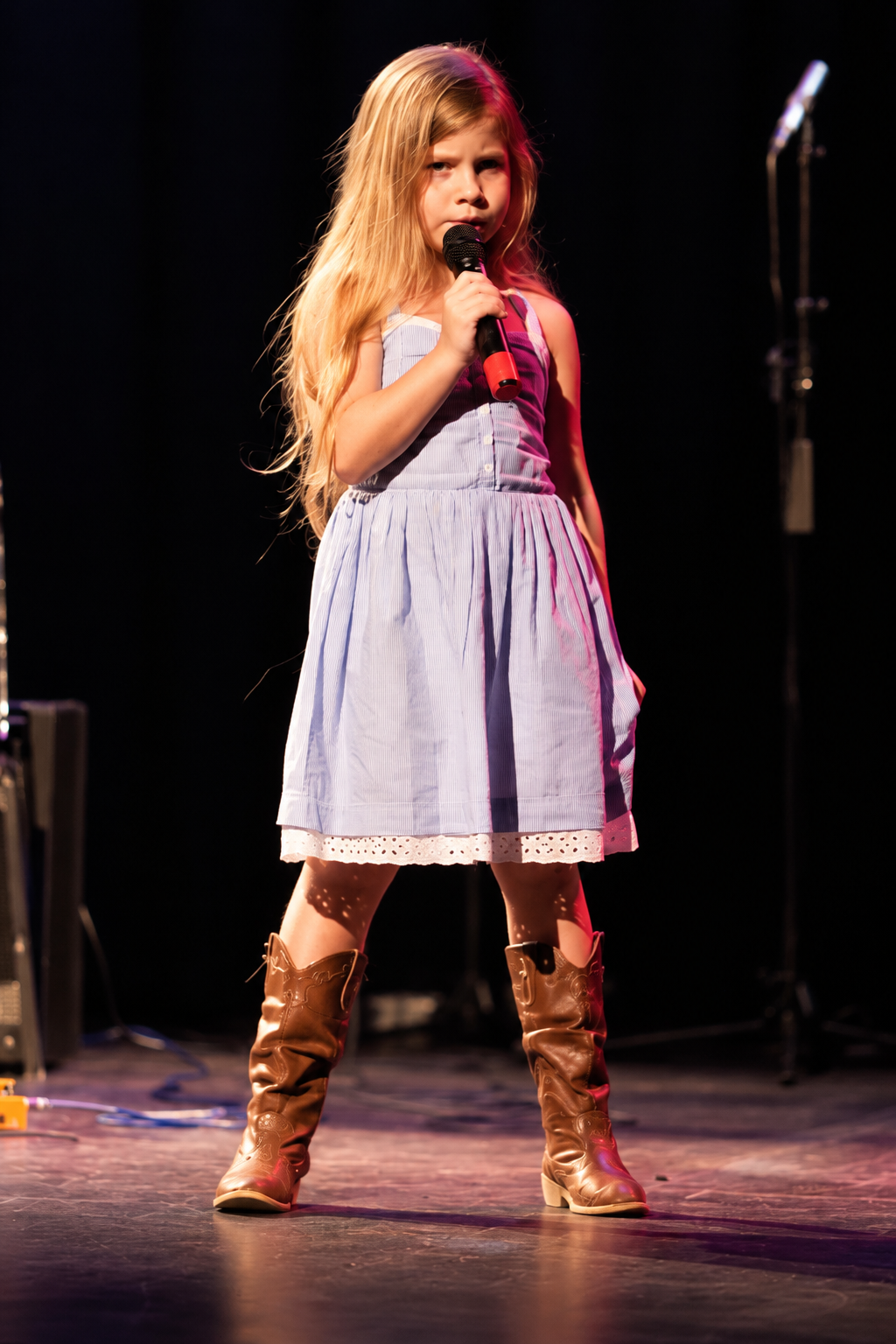 Vocalist at a microphone on stage · MBMS archive
